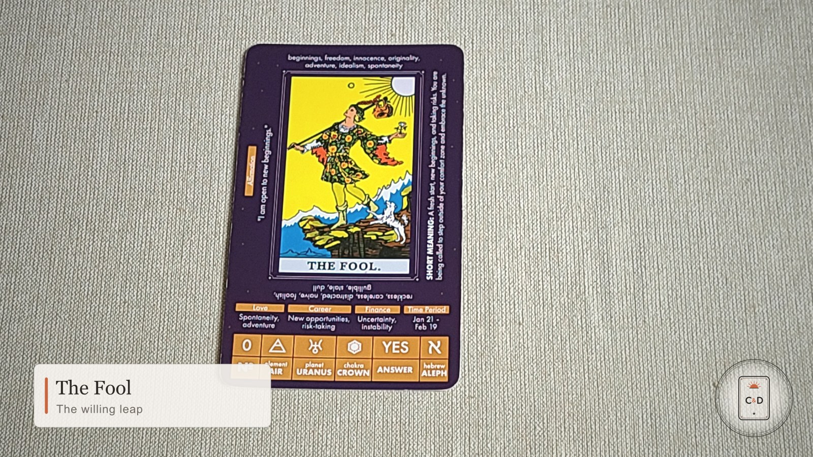 The Fool tarot card meaning, the card face-up on linen in warm natural light
