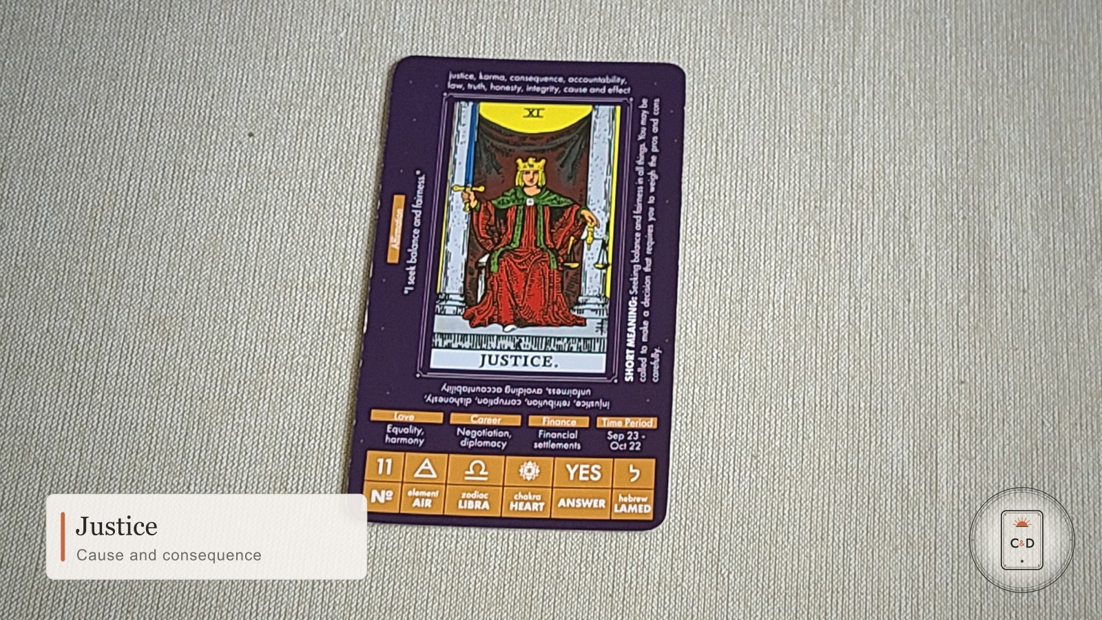 Tarot: Justice 1 Justice tarot card meaning, the card face-up on linen in warm natural light