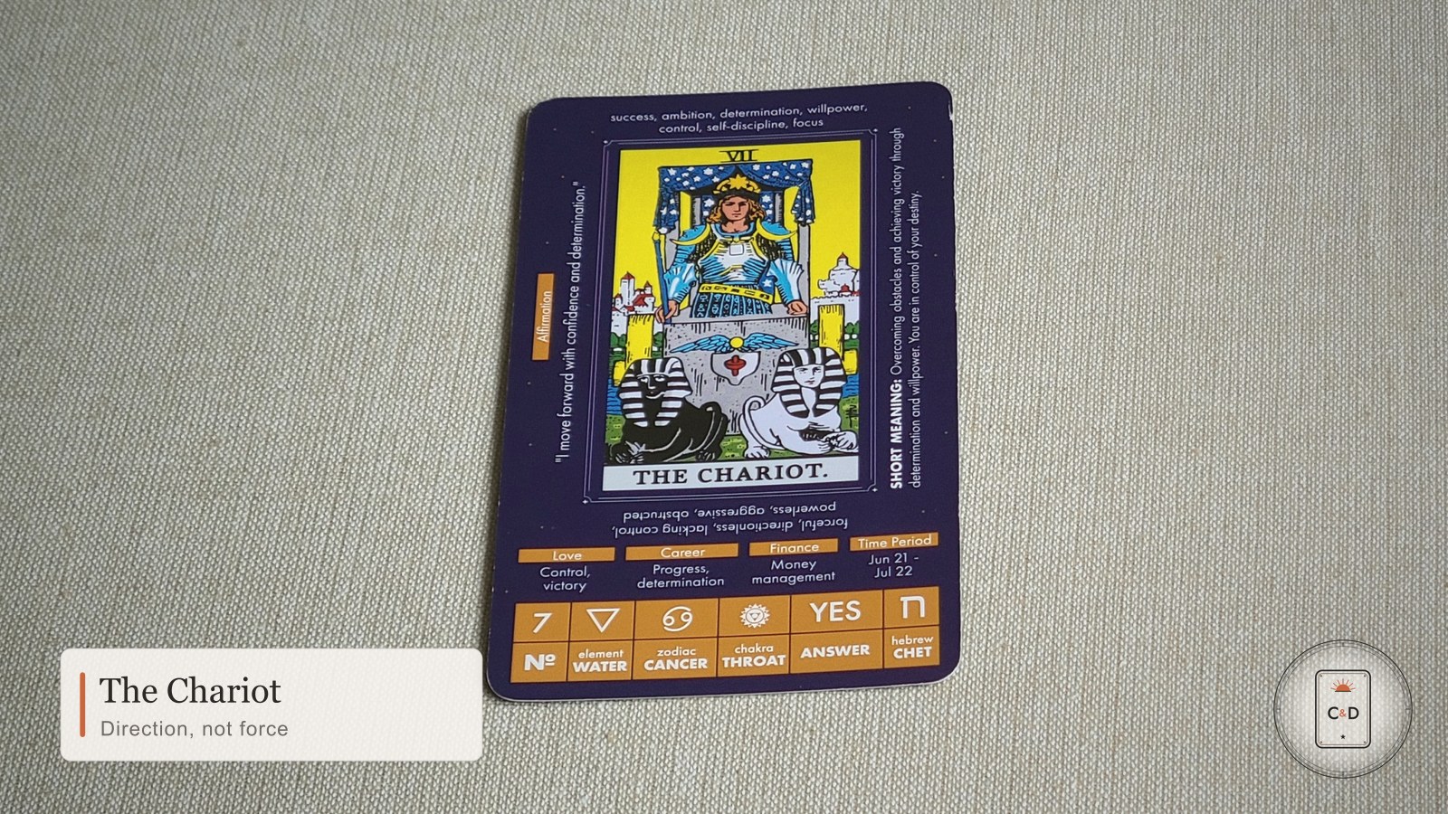 The Chariot tarot card meaning, the card face-up on linen in warm natural light