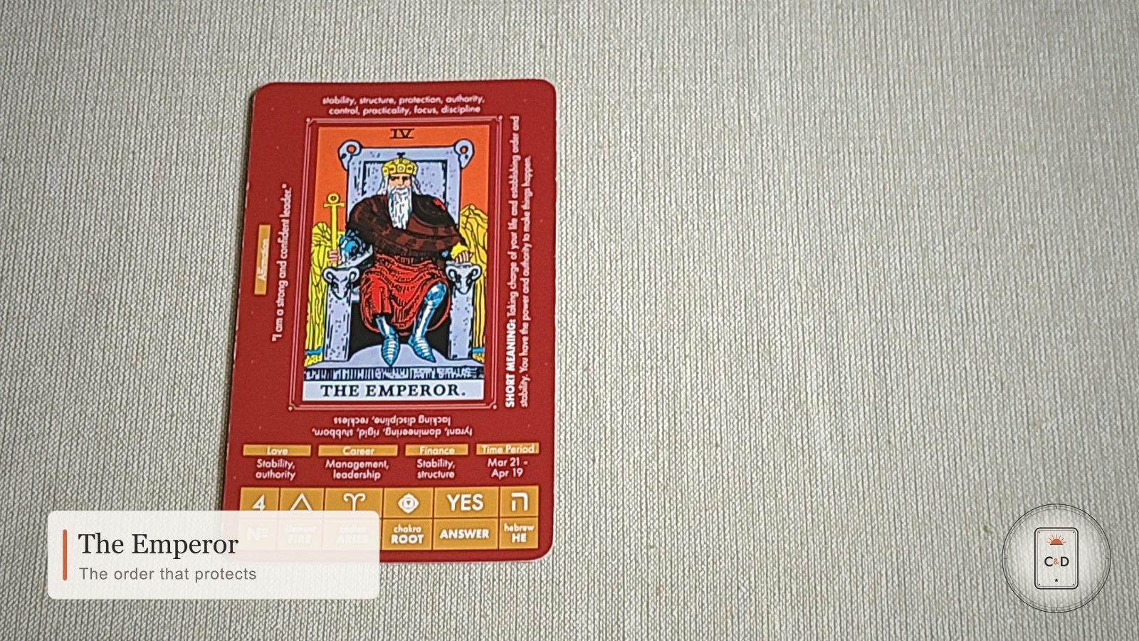 The Emperor tarot card meaning, the card face-up on linen in warm natural light