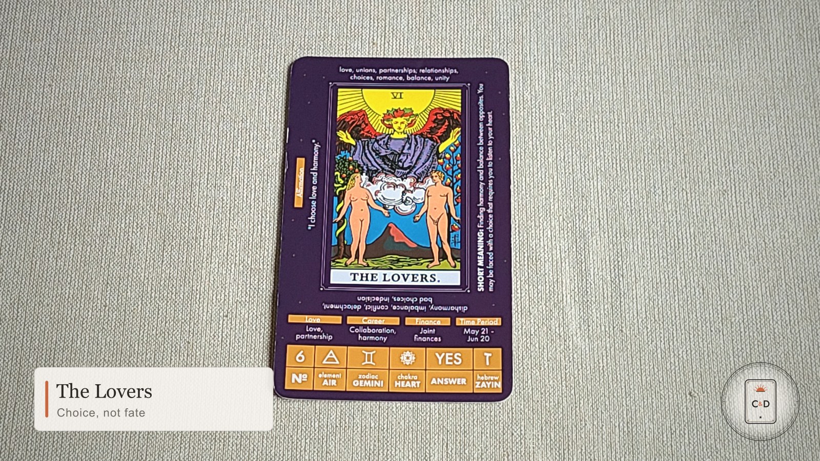 The Lovers tarot card meaning, the card face-up on linen in warm natural light