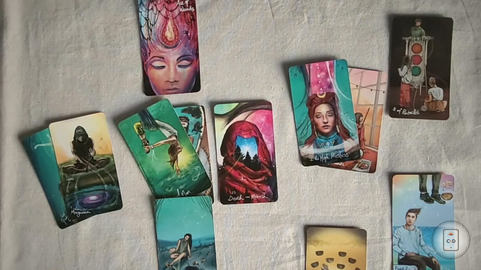 How does tarot work: a full tarot spread laid out on linen at the reading table, seen from above in warm daylight